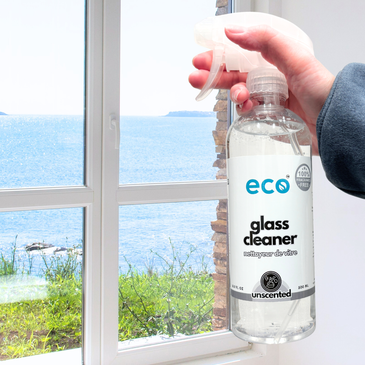 Eco Glass cleaner cleaning a window to be streak-free, shiny, and smudge-free.